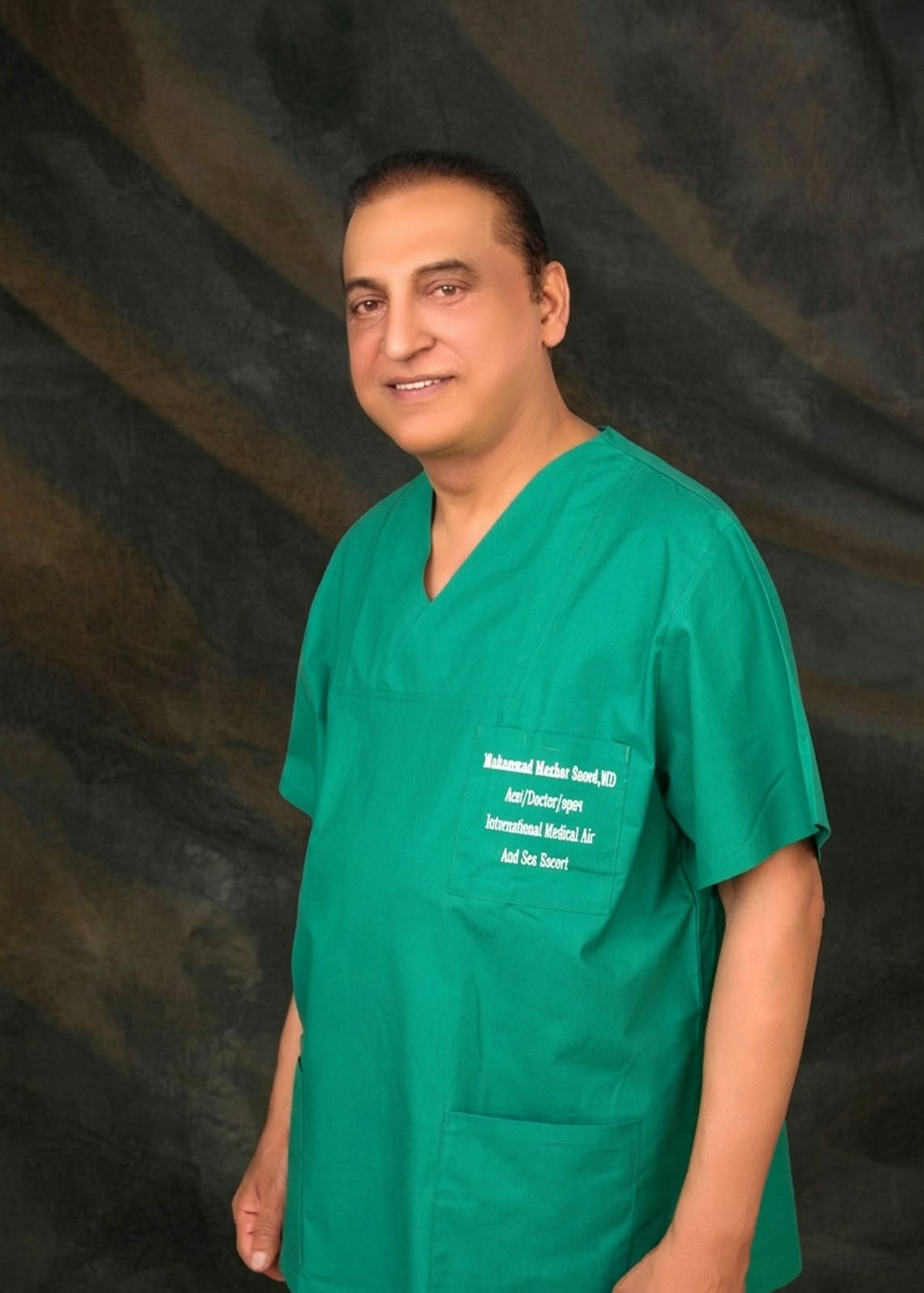 Dr. Muhammad Mazher Saeed in scrubs
